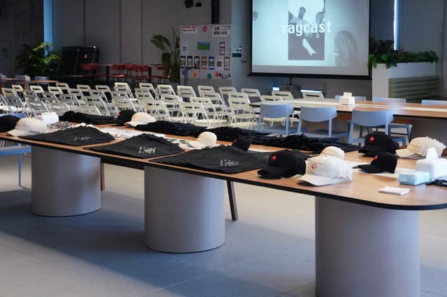 Classroom training room with tables arranged and supplies laid out facing a projector screen